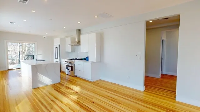 a kitchen with a refrigerator and a stove top oven