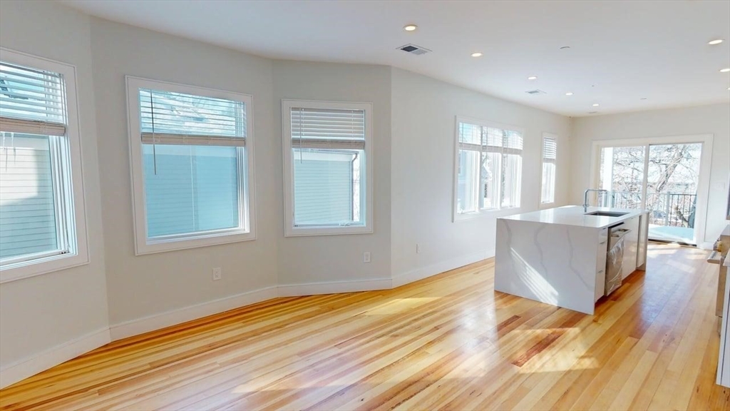 179 Appleton Street, Unit 2 Cambridge, MA 02138 - Photo 5 of 23 a view of kitchen and hall with wooden floor