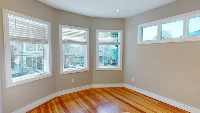 a view of a room with wooden floor and a window