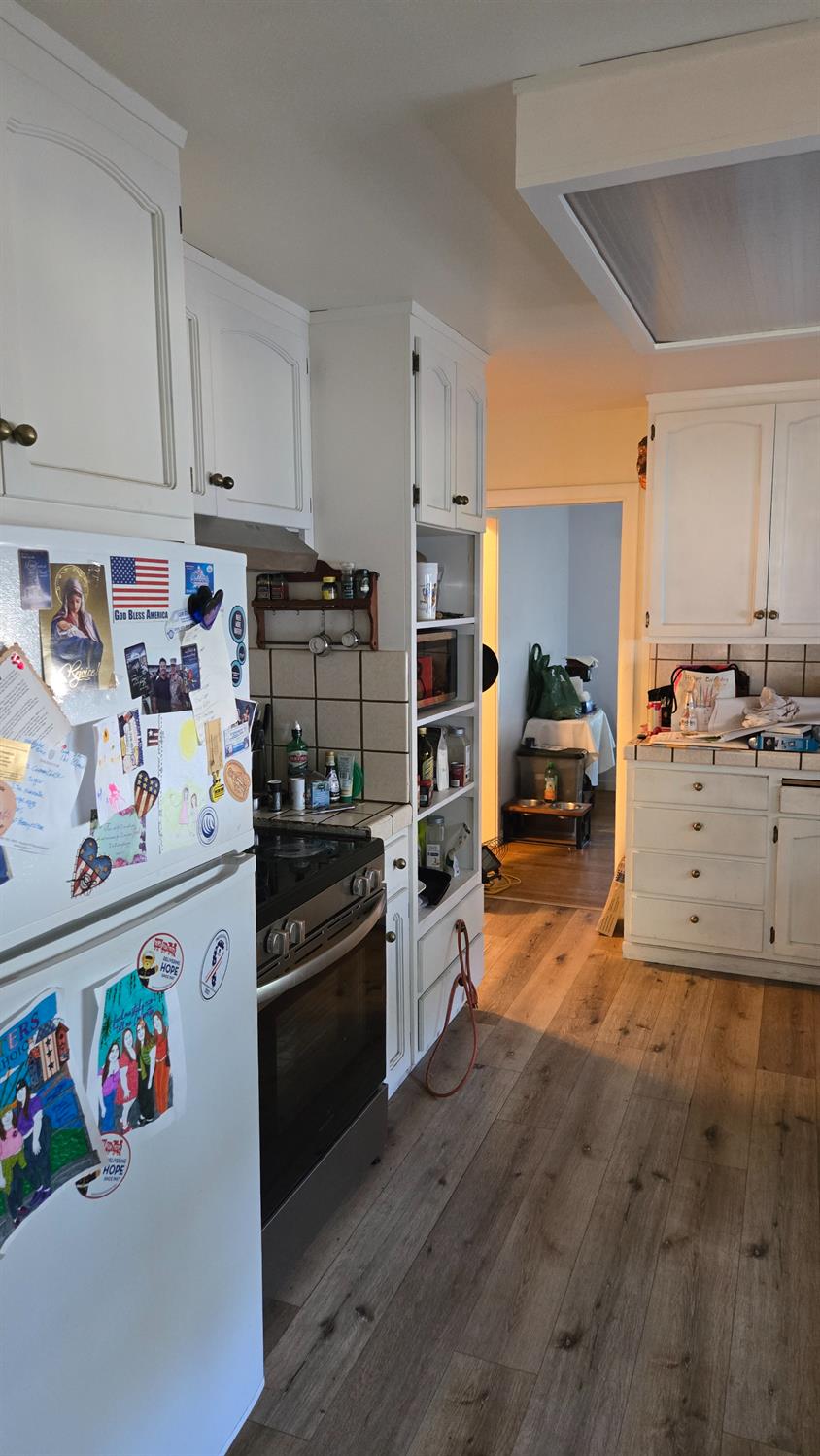 8043 Valencia Avenue Stockton, CA 95209 - Photo 3 of 15 a kitchen with granite countertop a sink and a stove top oven