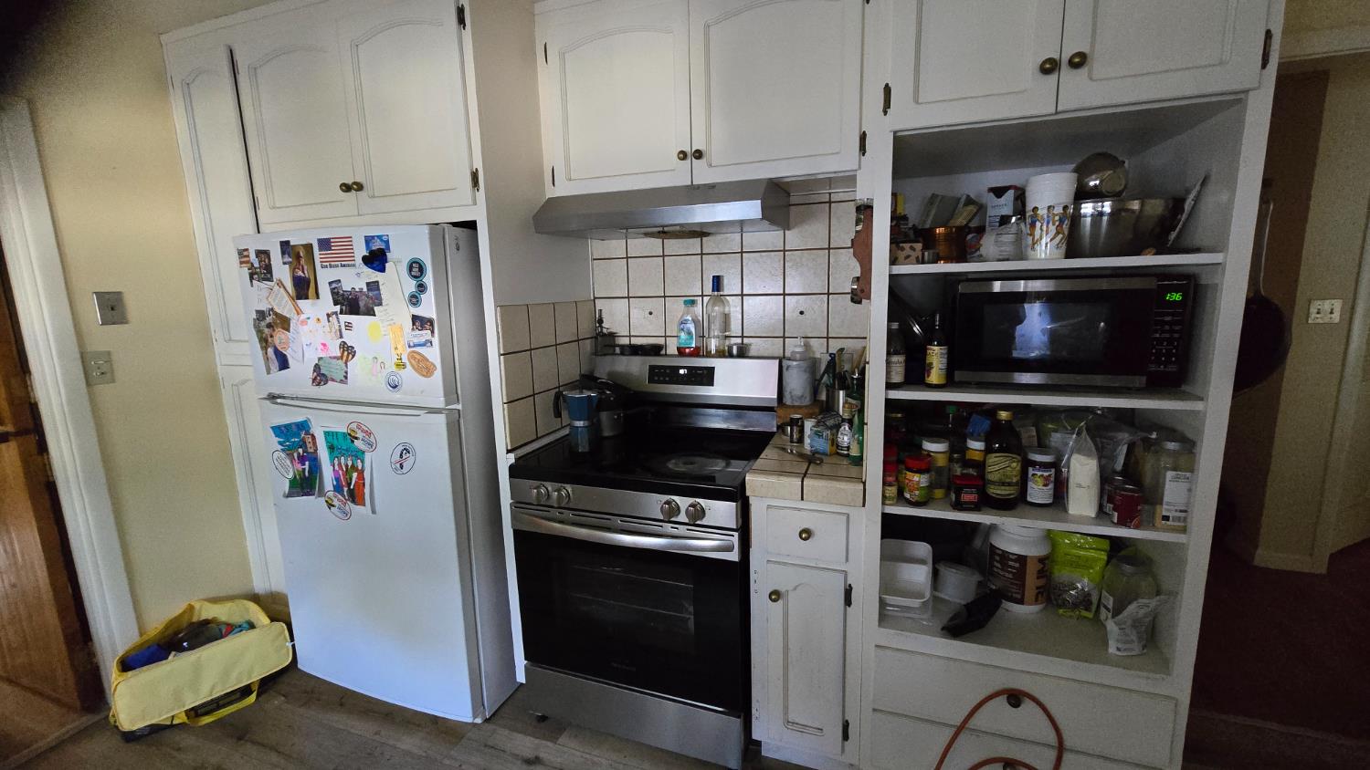 8043 Valencia Avenue Stockton, CA 95209 - Photo 4 of 15 a kitchen with refrigerator and cabinets