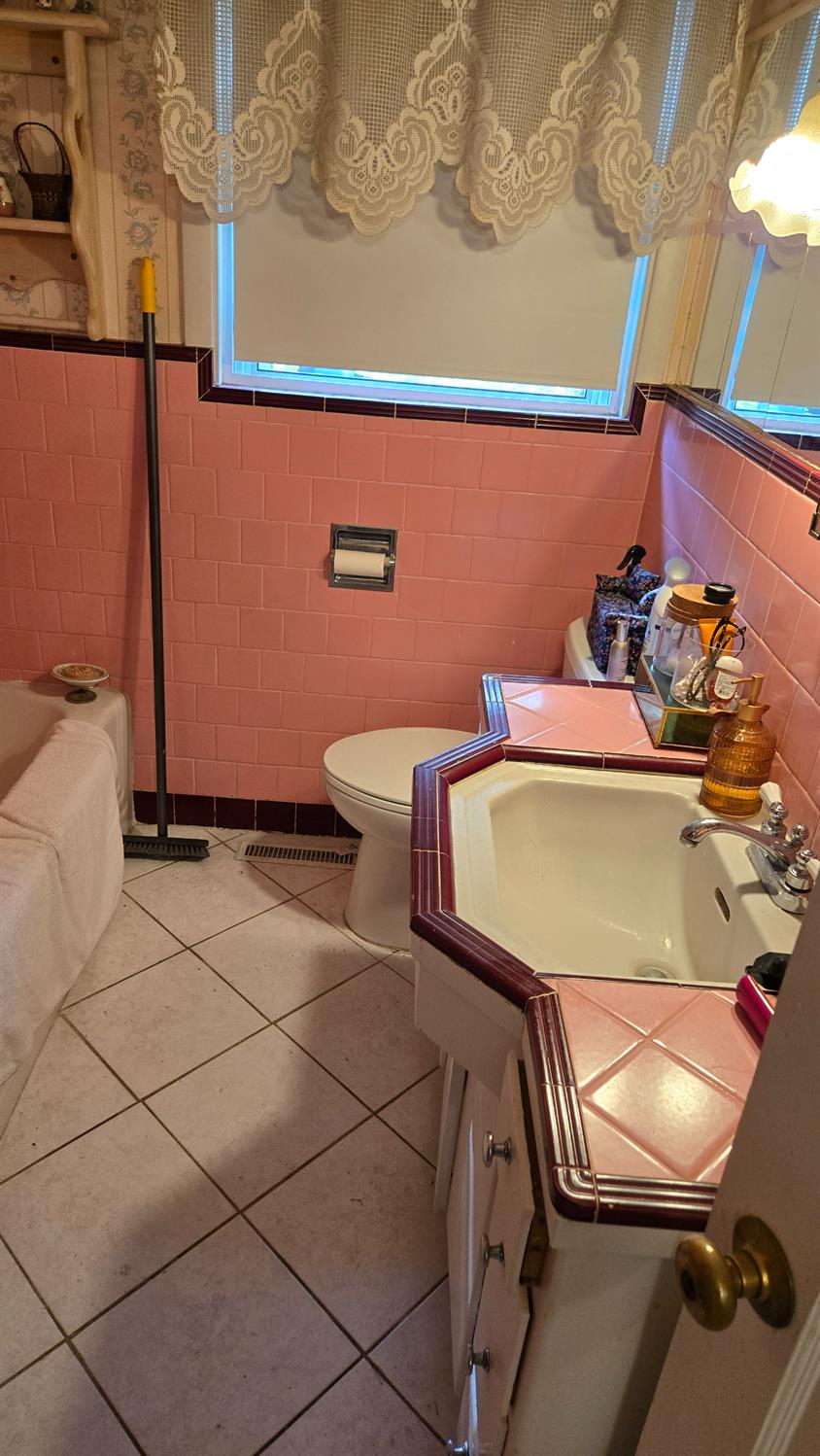 8043 Valencia Avenue Stockton, CA 95209 - Photo 9 of 15 a bathroom with a sink a toilet and a mirror