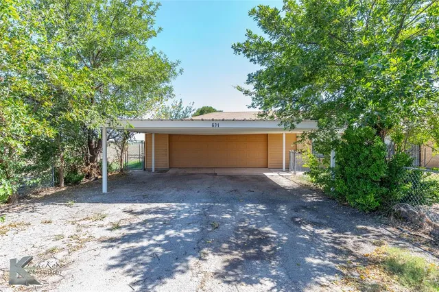 a view of a house with a yard and garage