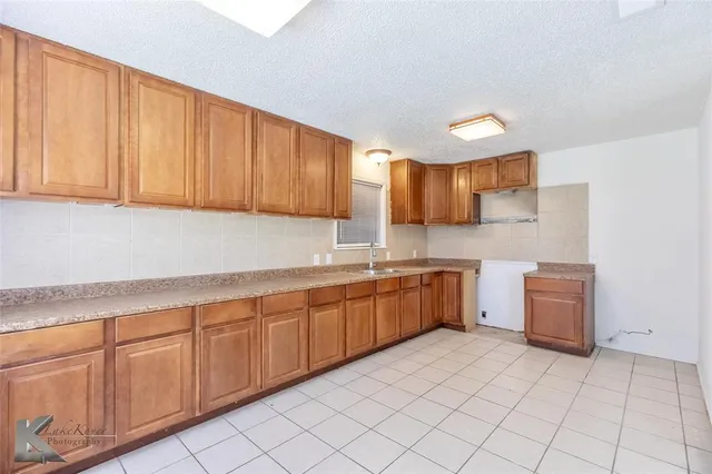 a kitchen with cabinets a sink and dishwasher