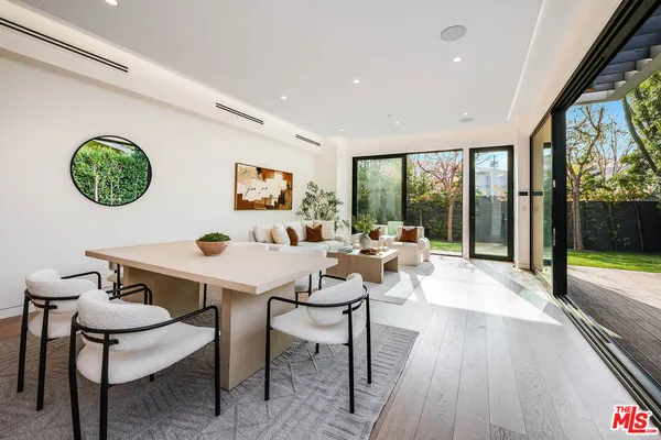 a view of a dining room with furniture wooden floor and a chandelier