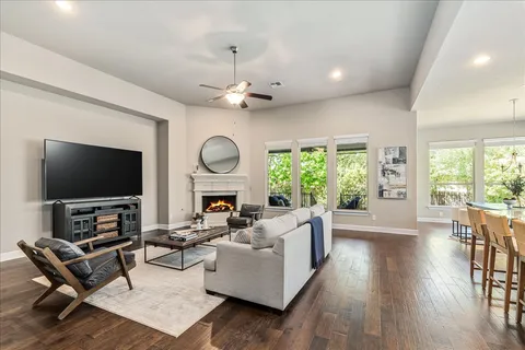 a living room with furniture a large window and a flat screen tv