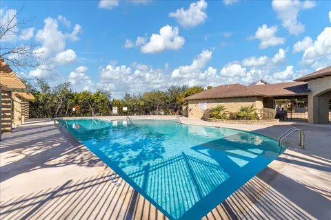 a view of a swimming pool with a patio