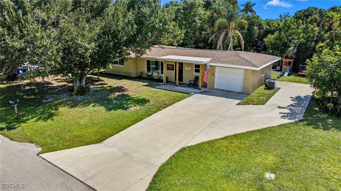 1420 Mandel Road Fort Myers, FL 33919 - Photo 1 of 41 a view of house with garden and tall tress