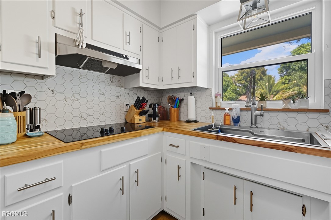 1420 Mandel Road Fort Myers, FL 33919 - Photo 18 of 41 a kitchen with stainless steel appliances white cabinets and a window
