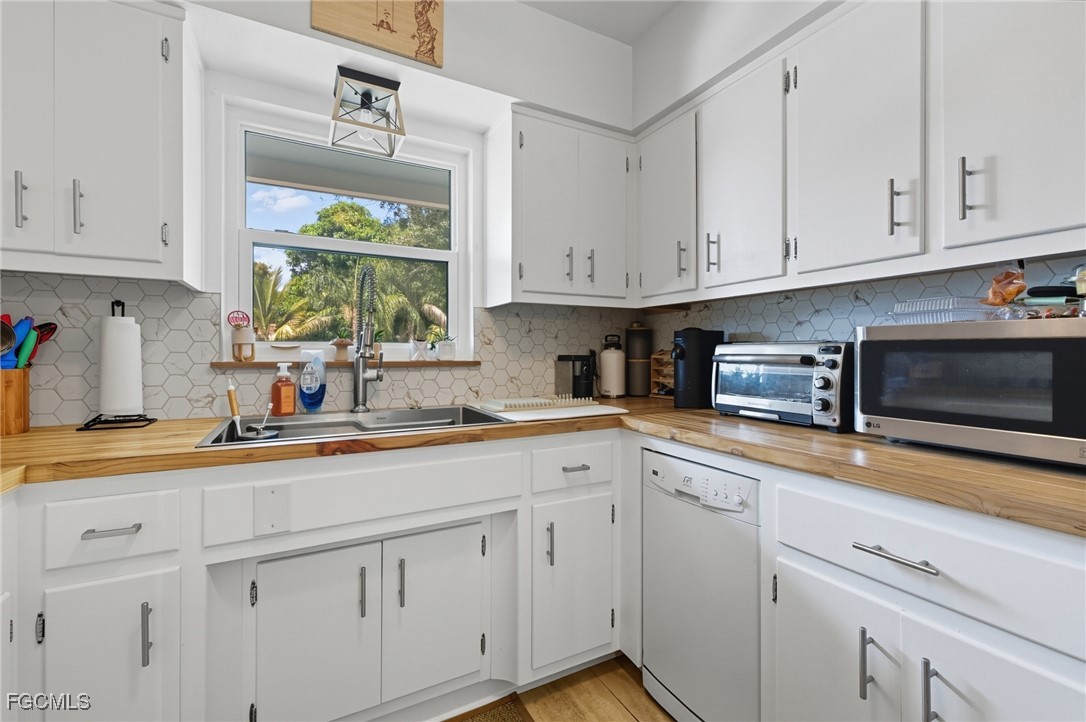 1420 Mandel Road Fort Myers, FL 33919 - Photo 19 of 41 a kitchen with white cabinets and window