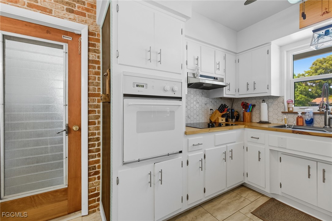 1420 Mandel Road Fort Myers, FL 33919 - Photo 20 of 41 a kitchen with white cabinets and white appliances