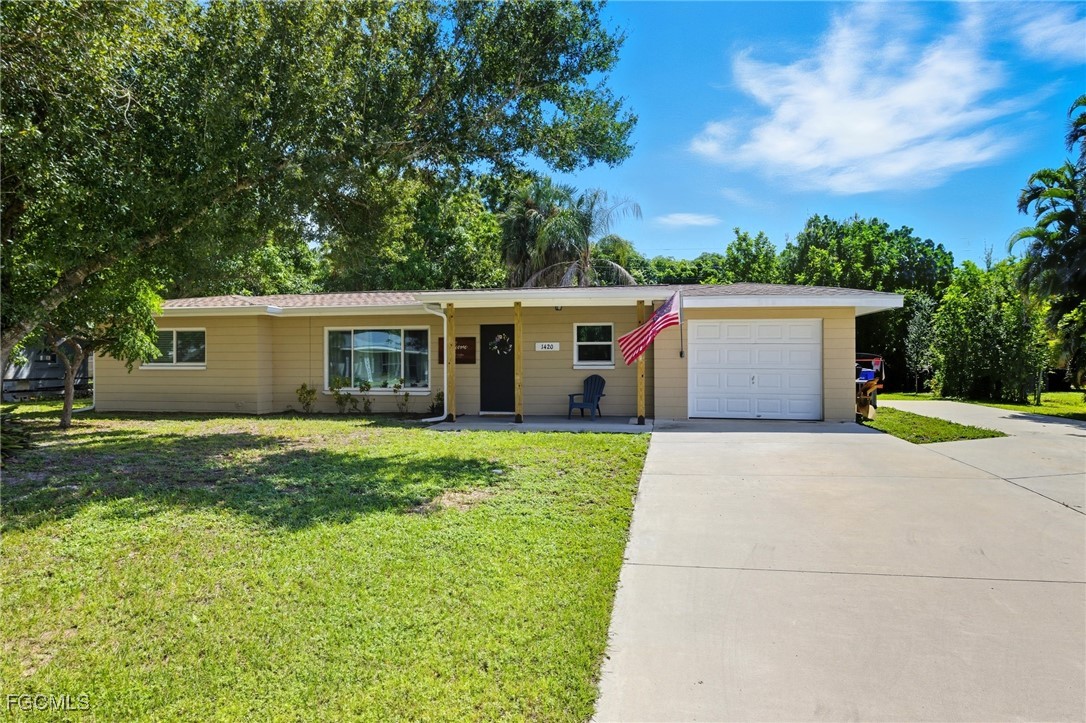 1420 Mandel Road Fort Myers, FL 33919 - Photo 36 of 41 a view of a house with a yard and garage