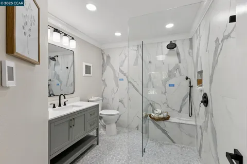 a bathroom with a sink toilet and shower