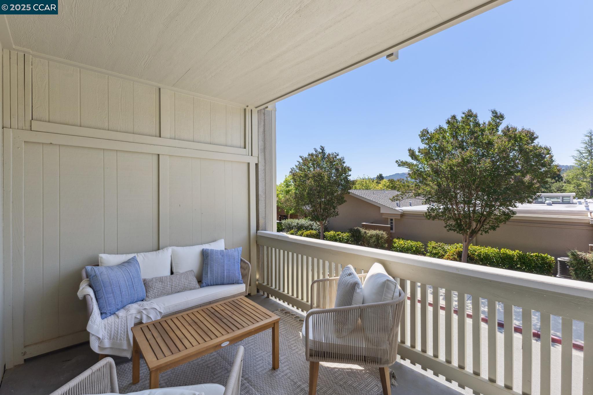 2101 Golden Rain Road, Unit 14 Walnut Creek, CA 94595 - Photo 40 of 52 a balcony view with a couple of couches and a table