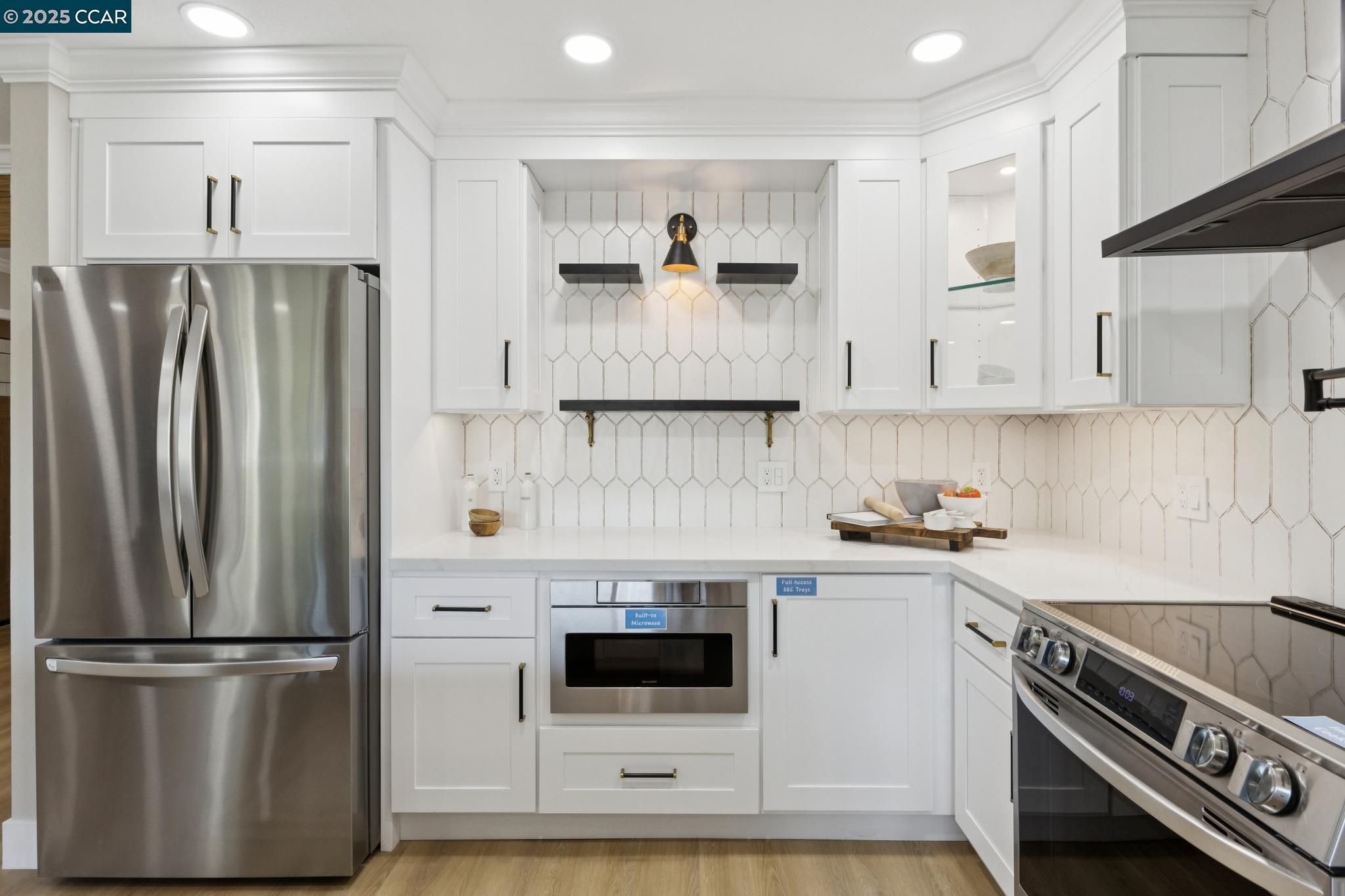 2101 Golden Rain Road, Unit 14 Walnut Creek, CA 94595 - Photo 5 of 52 a kitchen with stainless steel appliances a refrigerator stove and microwave