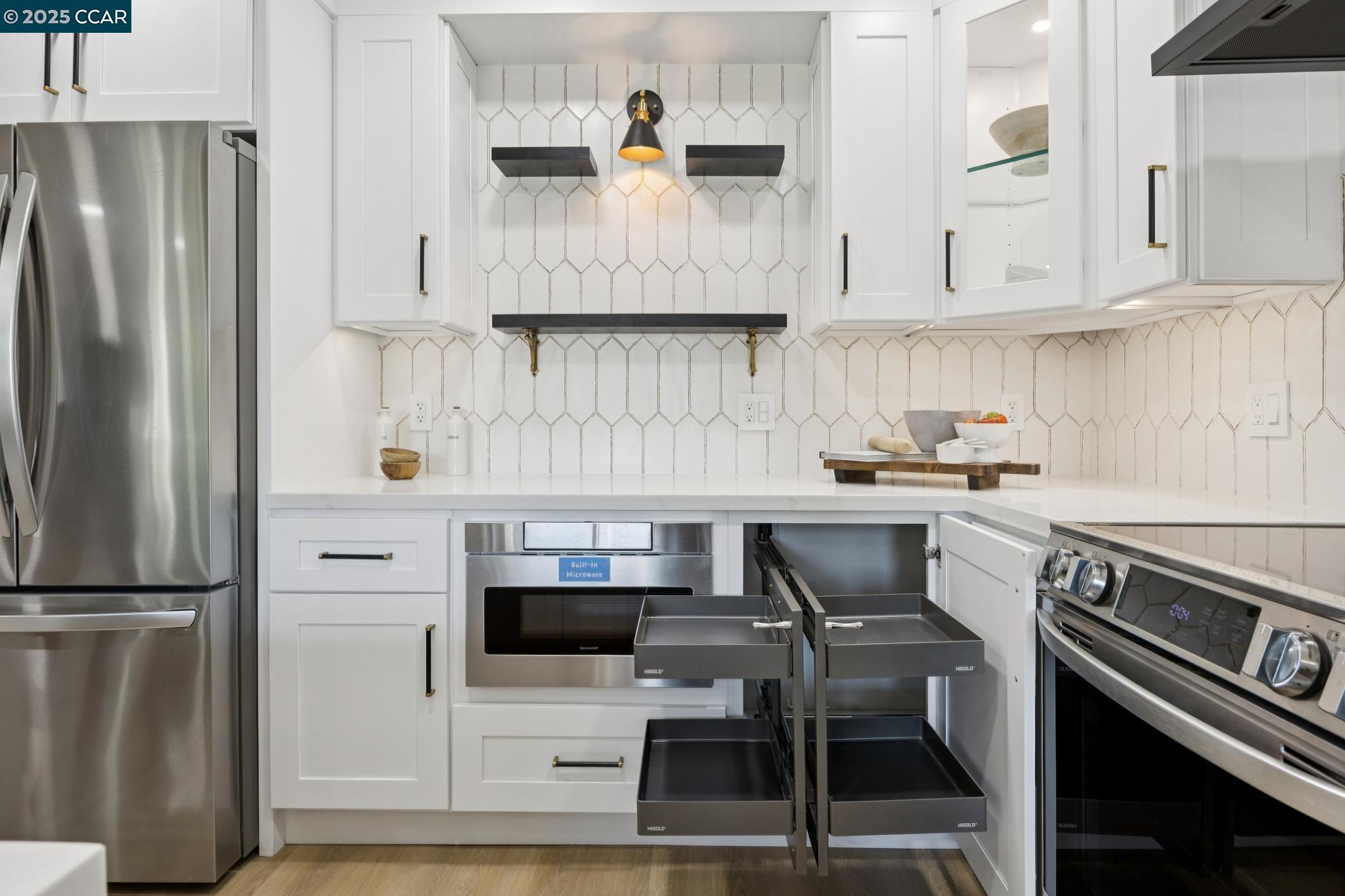 2101 Golden Rain Road, Unit 14 Walnut Creek, CA 94595 - Photo 6 of 52 a kitchen with stainless steel appliances a refrigerator a stove and white cabinets