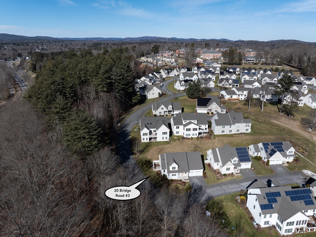 20 Bridge Road, Unit 3 Northampton, MA 01062 - Photo 33 of 36 an aerial view of a house with lots of residential buildings and mountain view in back