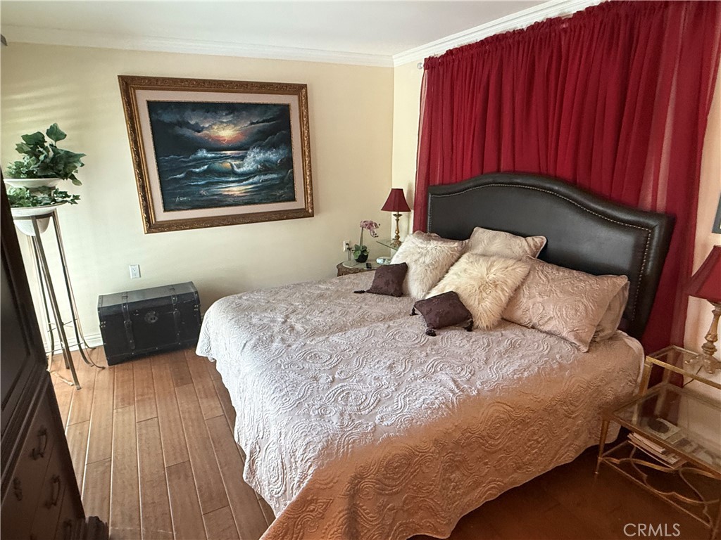 199 Avenida Majorca, Unit C Laguna Woods, CA 92637 - Photo 18 of 30 a bedroom with a bed and a painting on the wall