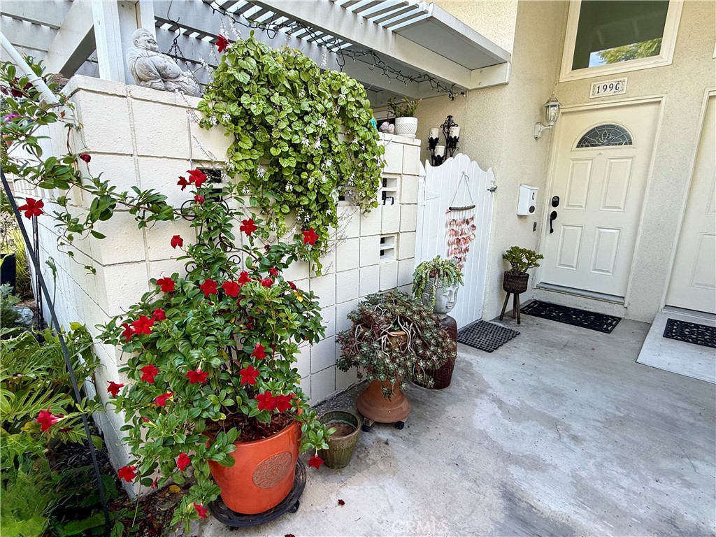 199 Avenida Majorca, Unit C Laguna Woods, CA 92637 - Photo 2 of 30 a flower plants sitting in front of a house