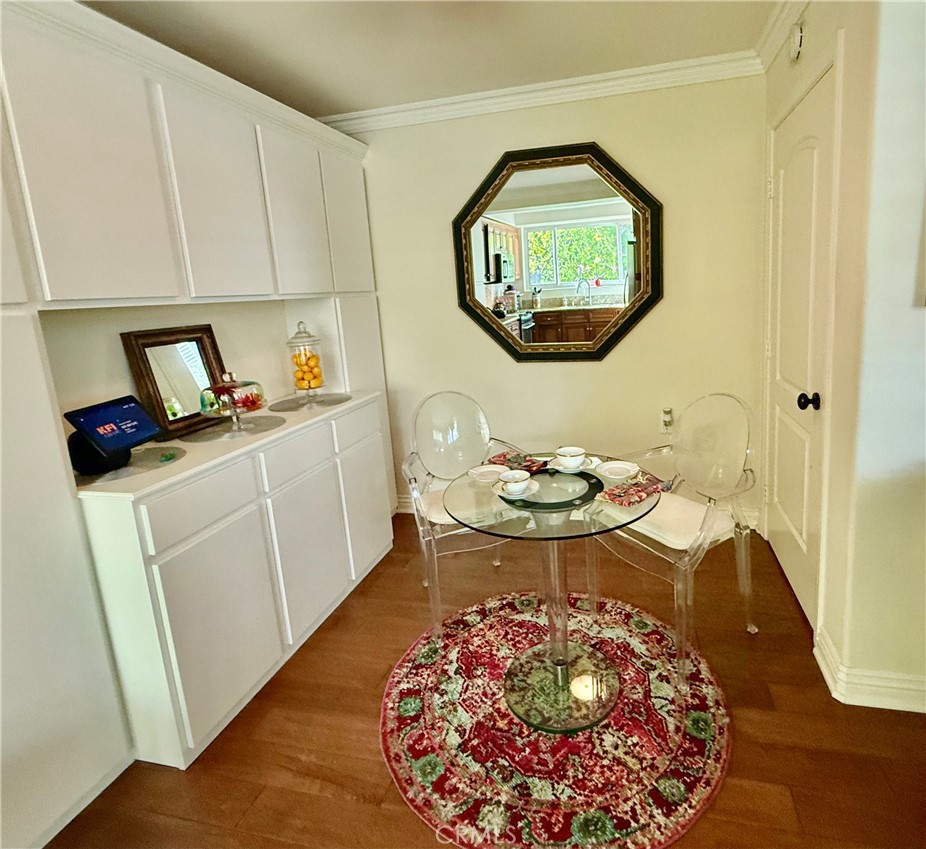 199 Avenida Majorca, Unit C Laguna Woods, CA 92637 - Photo 24 of 30 a view of a kitchen area with furniture and wooden floor
