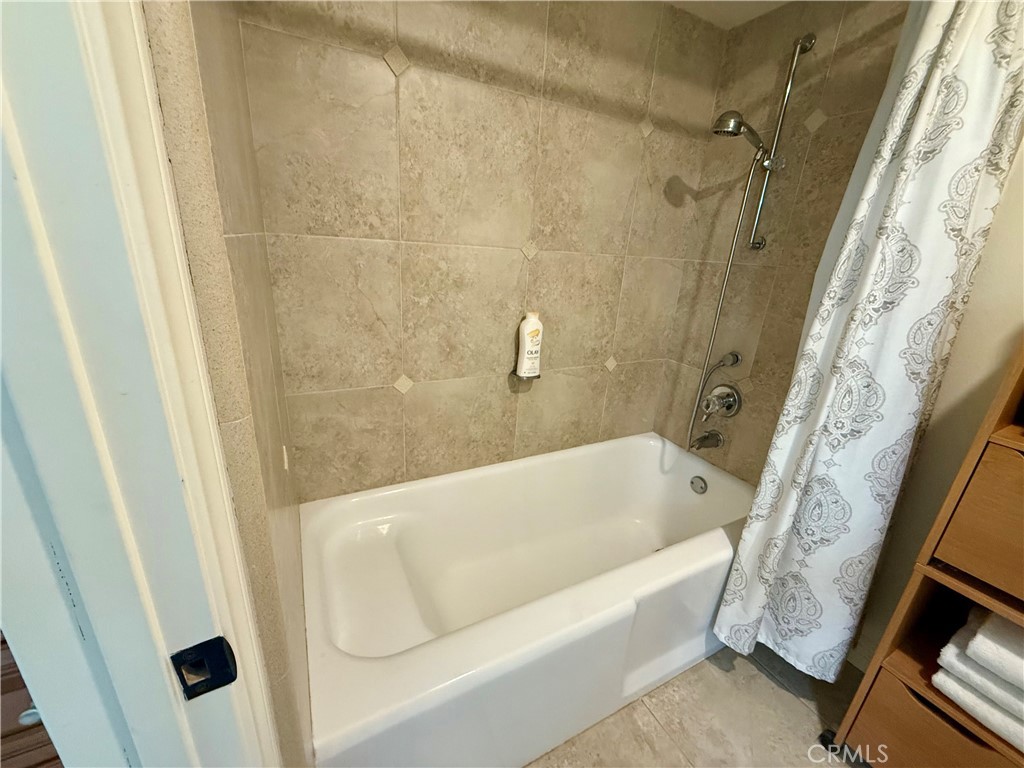 199 Avenida Majorca, Unit C Laguna Woods, CA 92637 - Photo 26 of 30 a bathroom with a tub a sink and a shower