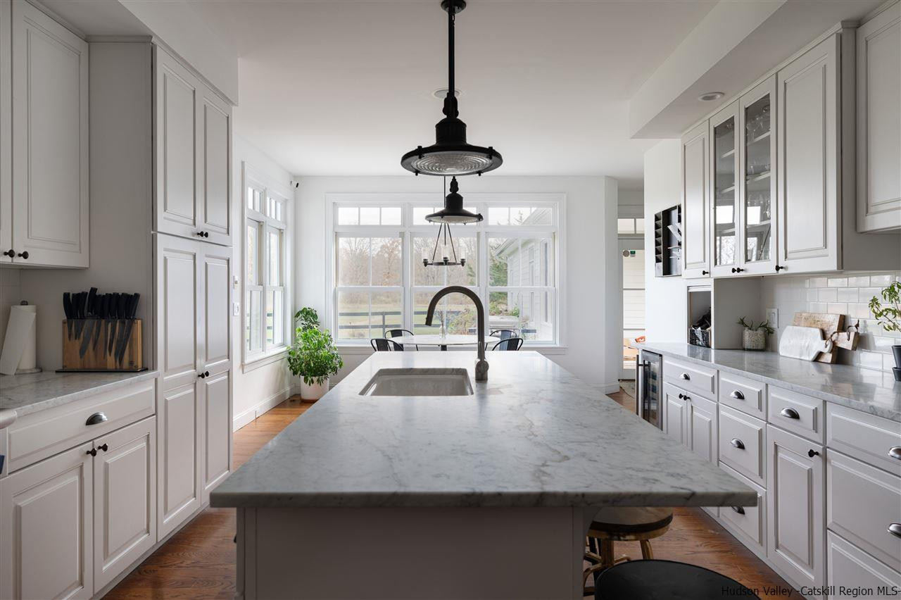 383 Pine Bush Road Stone Ridge, NY 12484 - Photo 11 of 35 a kitchen with stainless steel appliances granite countertop a stove refrigerator and cabinets