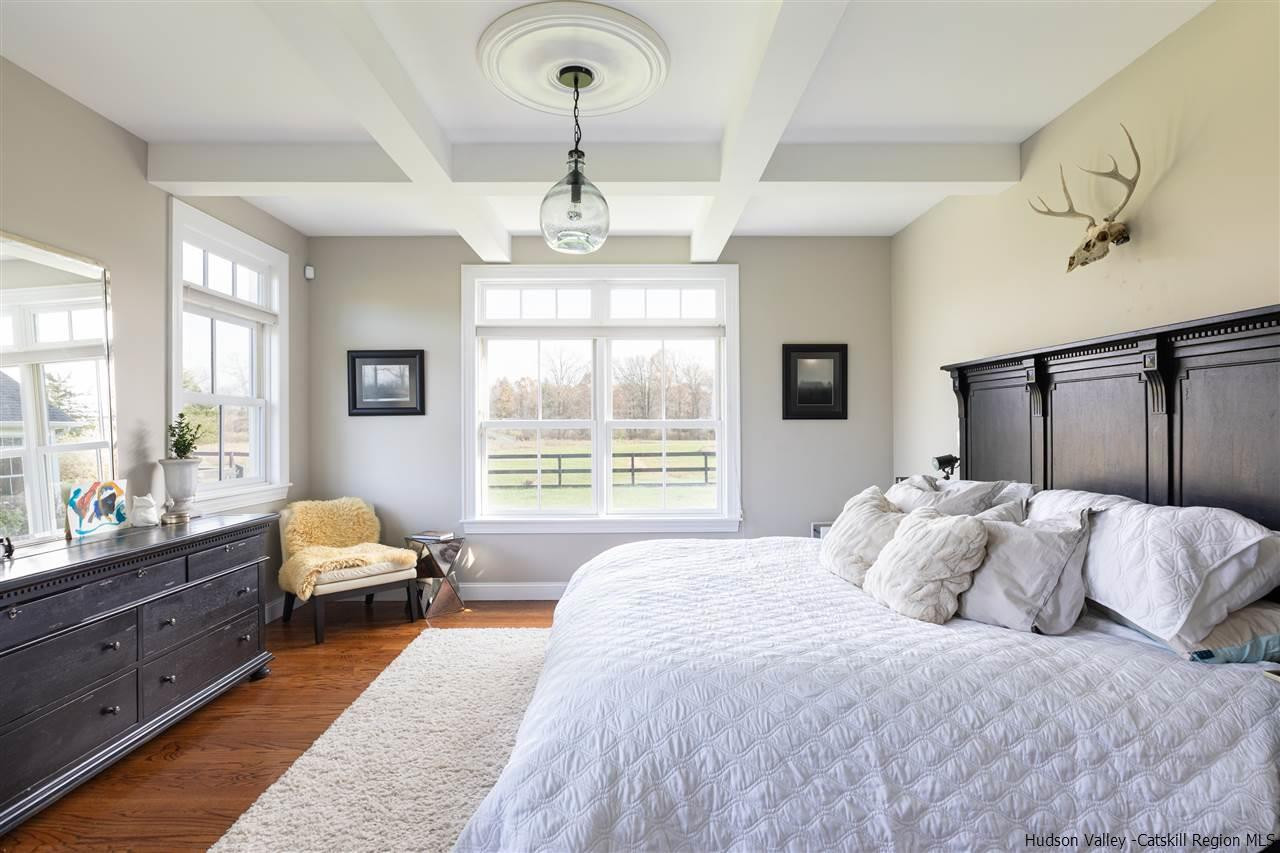 383 Pine Bush Road Stone Ridge, NY 12484 - Photo 15 of 35 a spacious bedroom with a bed and wooden floor
