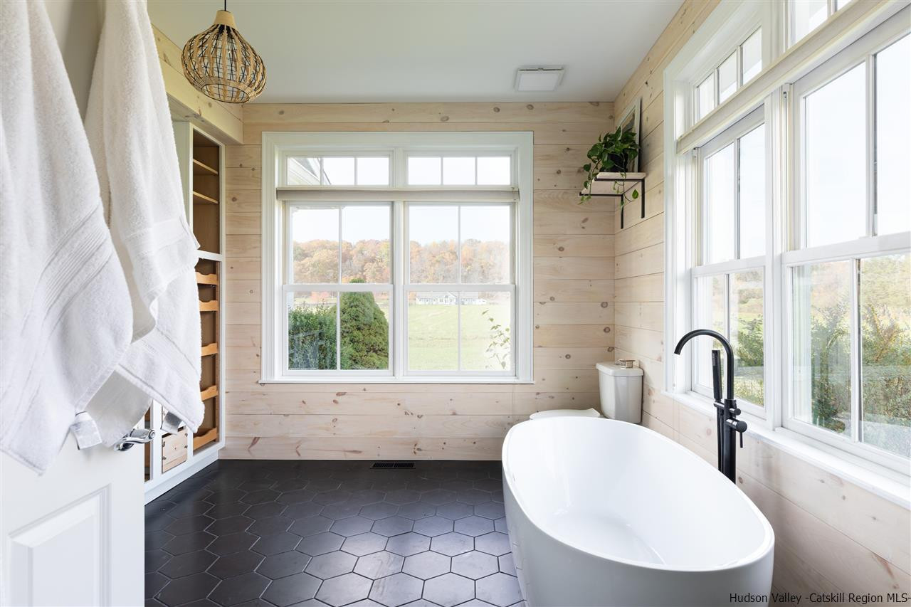 383 Pine Bush Road Stone Ridge, NY 12484 - Photo 17 of 35 a bathroom with a tub sink and mirror