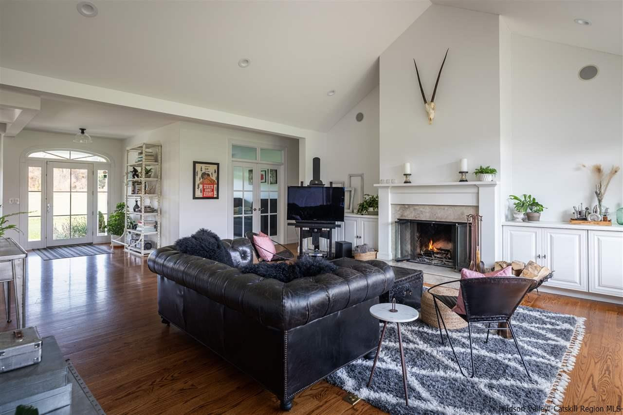 383 Pine Bush Road Stone Ridge, NY 12484 - Photo 2 of 35 a living room with furniture a rug and a fireplace