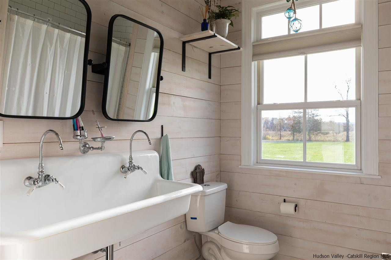 383 Pine Bush Road Stone Ridge, NY 12484 - Photo 21 of 35 a bathroom with a toilet sink and mirror