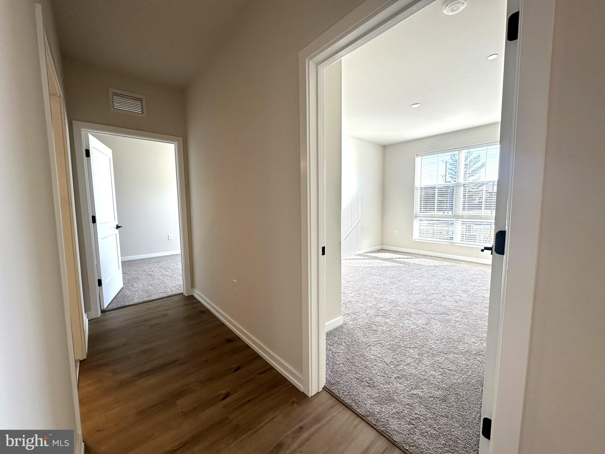 409 West Butler Avenue, Unit 318 Chalfont, PA 18914 - Photo 12 of 32 a view of a hallway with wooden floor and a room
