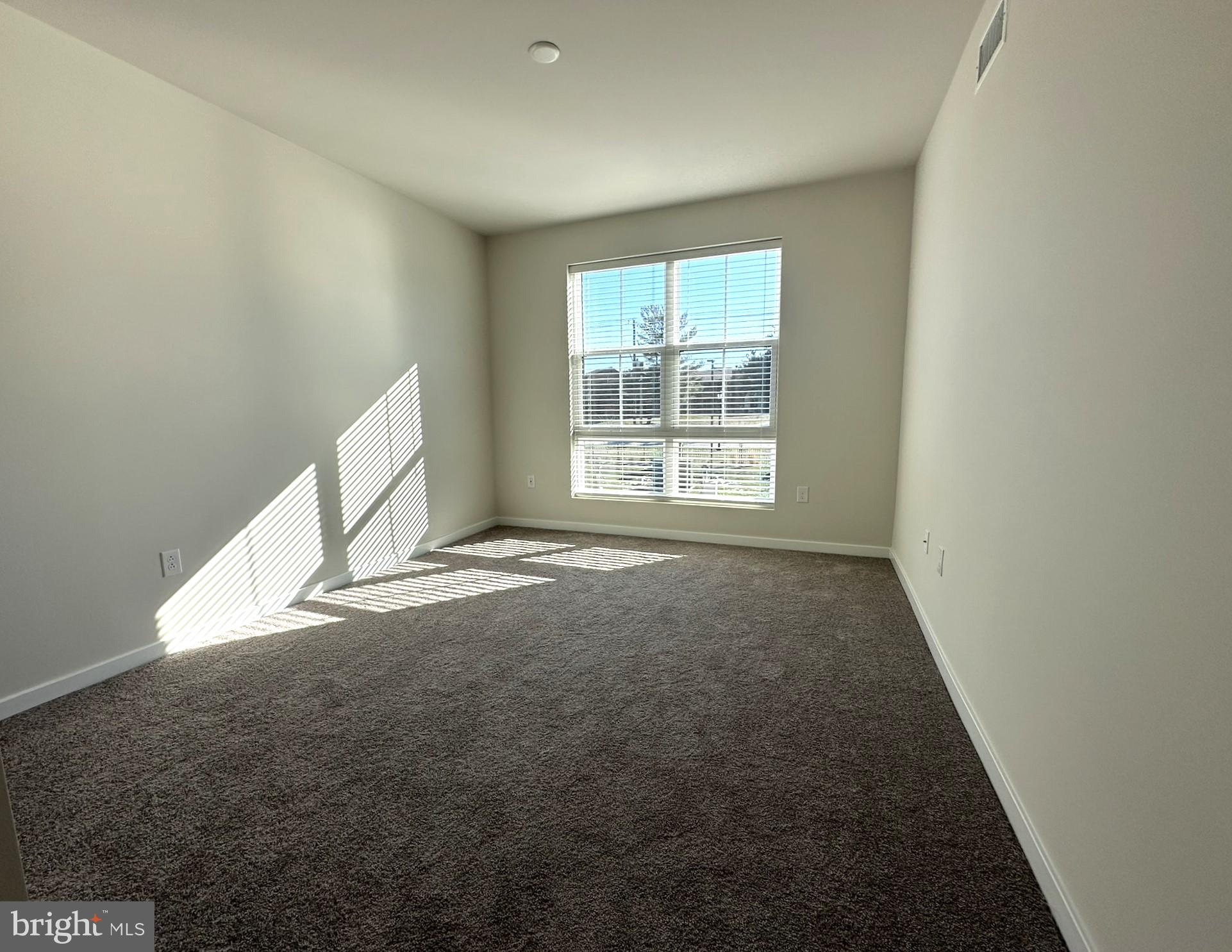 409 West Butler Avenue, Unit 318 Chalfont, PA 18914 - Photo 13 of 32 an empty room with a empty space and window