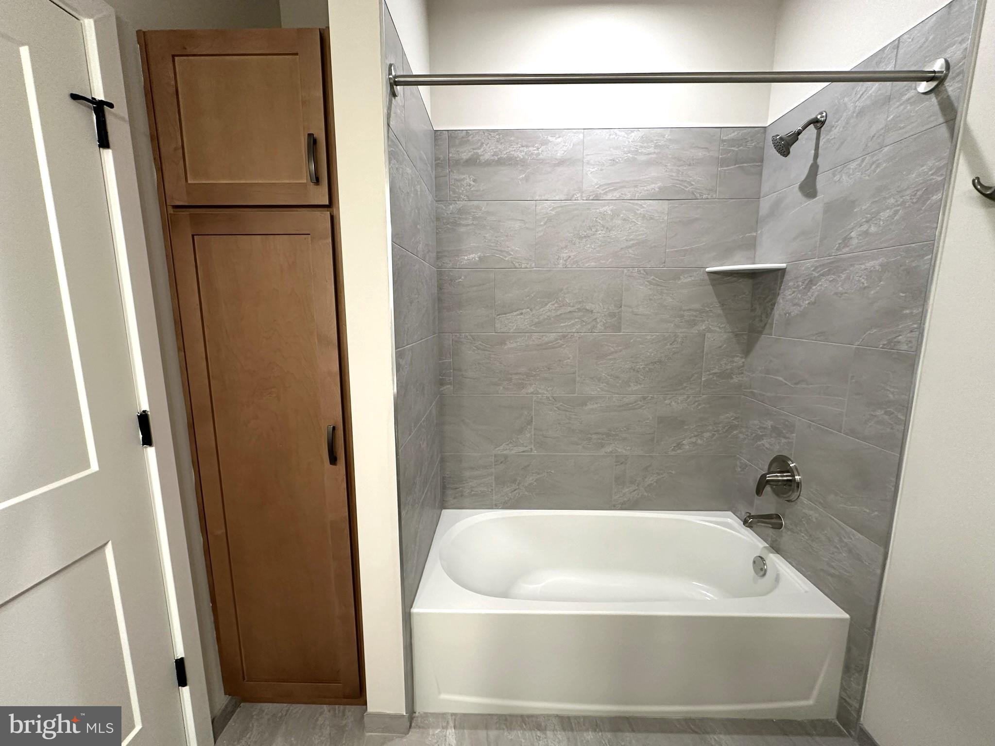 409 West Butler Avenue, Unit 318 Chalfont, PA 18914 - Photo 17 of 32 a bathroom with a white bath tub