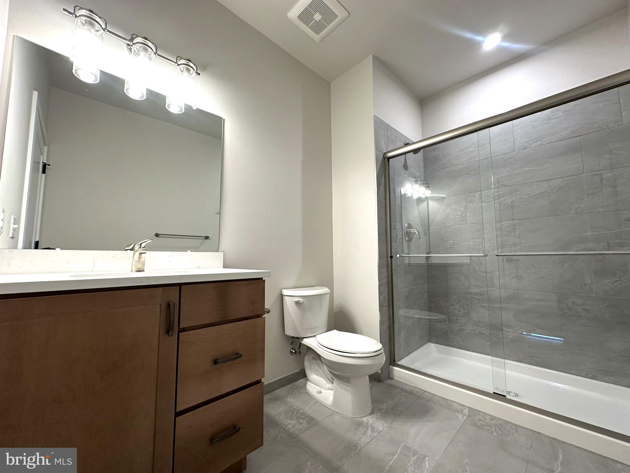 409 West Butler Avenue, Unit 318 Chalfont, PA 18914 - Photo 21 of 32 a bathroom with a sink toilet and shower