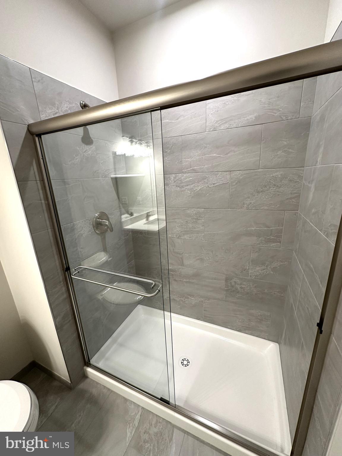 409 West Butler Avenue, Unit 318 Chalfont, PA 18914 - Photo 22 of 32 a bathroom with a shower and toilet