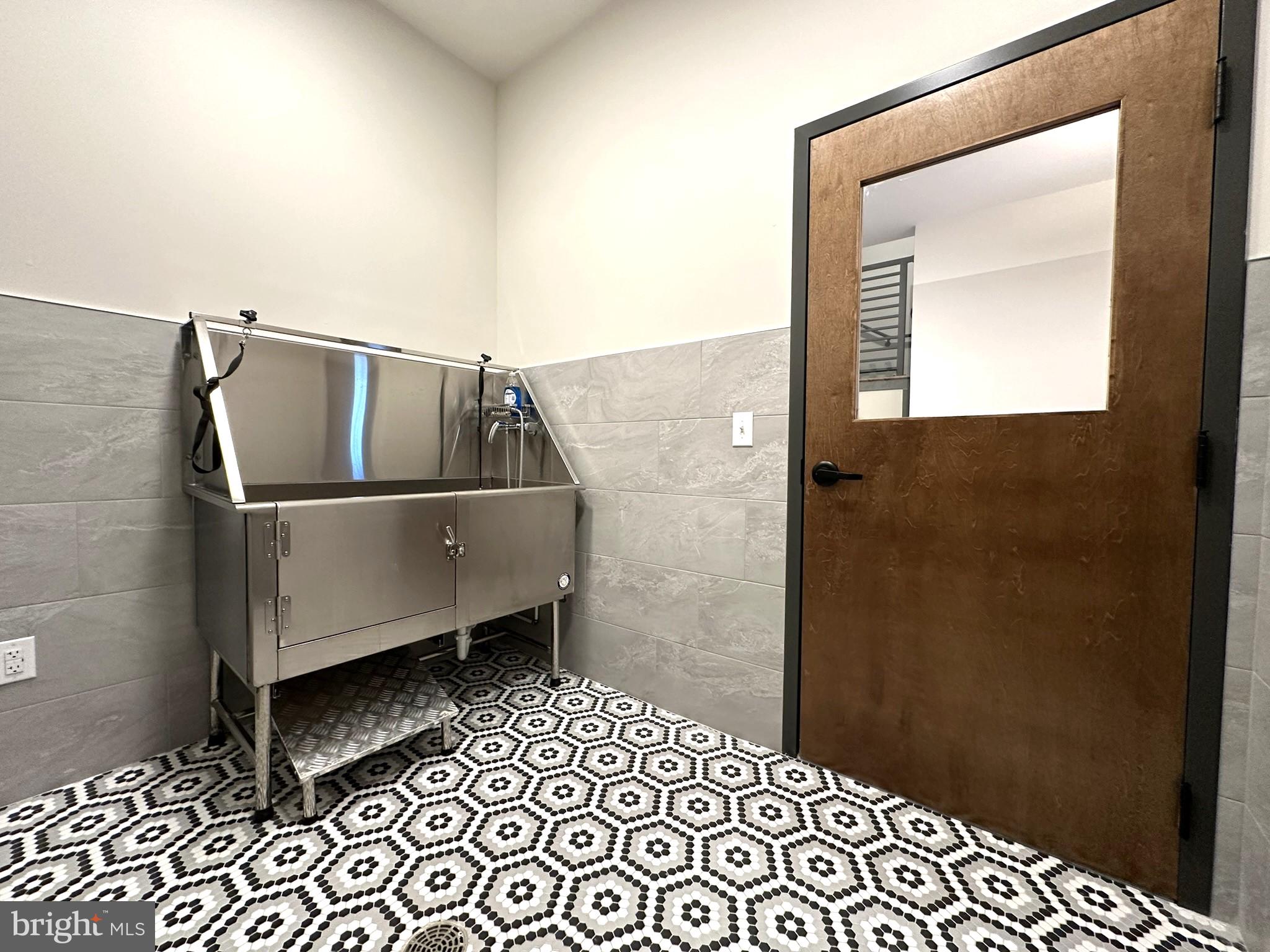 409 West Butler Avenue, Unit 318 Chalfont, PA 18914 - Photo 31 of 32 a room with a wooden floor and a sink