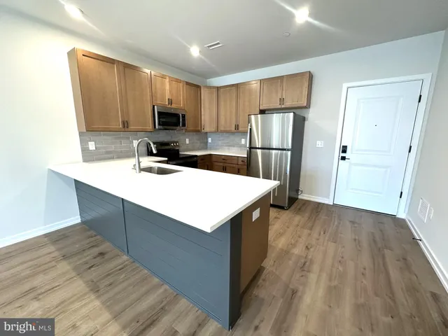 a kitchen with a refrigerator sink and microwave