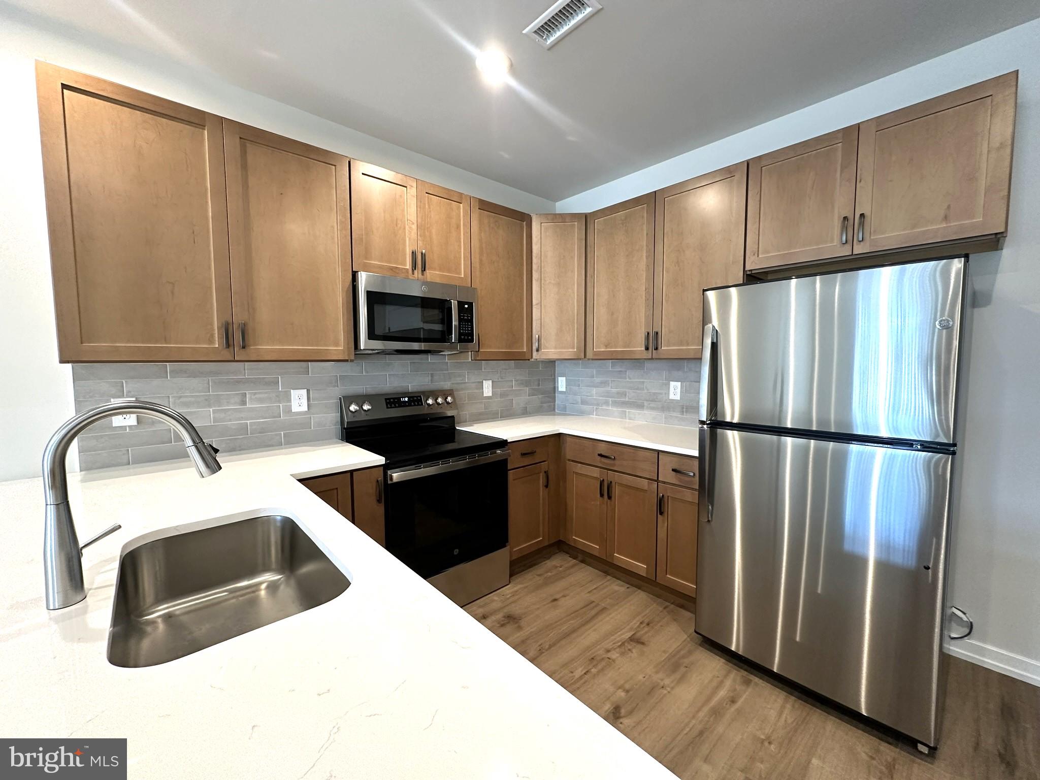 409 West Butler Avenue, Unit 318 Chalfont, PA 18914 - Photo 8 of 32 a kitchen with a refrigerator sink and microwave