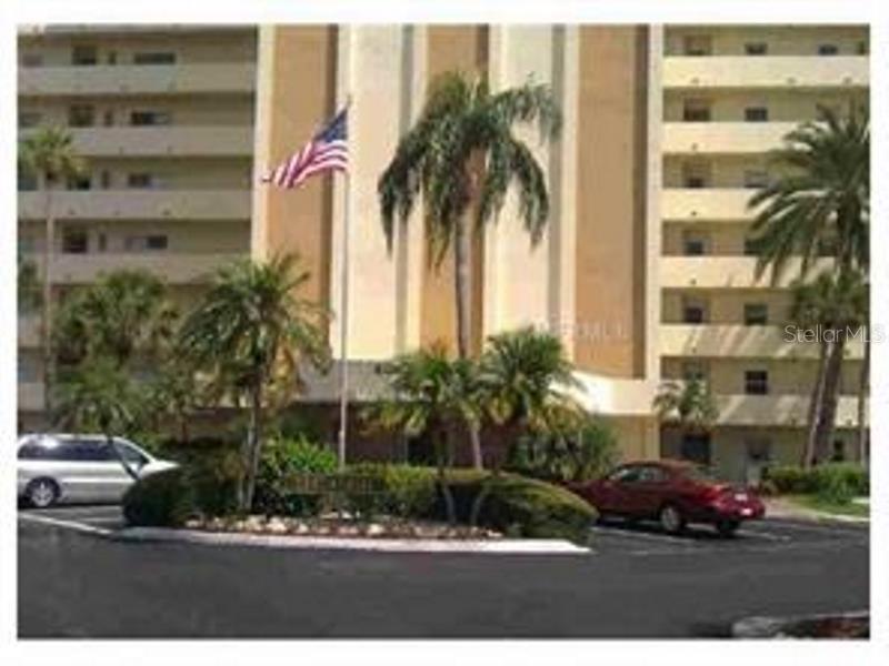 4775 Cove Circle, Unit 404 St. Petersburg, FL 33708 - Photo 1 of 1 a couple of palm trees in front of building