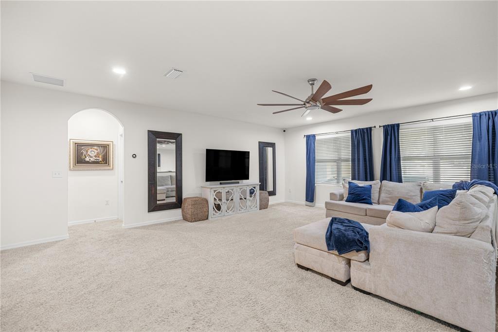 3833 Southeast 98th Place Belleview, FL 34420 - Photo 12 of 34 a living room with furniture and a flat screen tv
