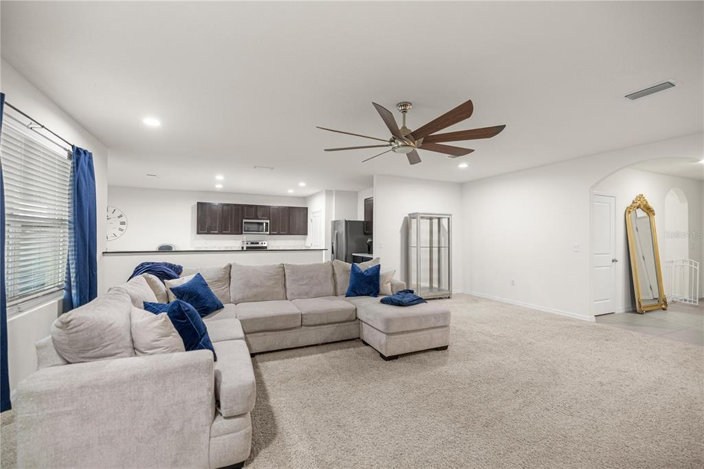 3833 Southeast 98th Place Belleview, FL 34420 - Photo 14 of 34 a living room with furniture and a ceiling fan