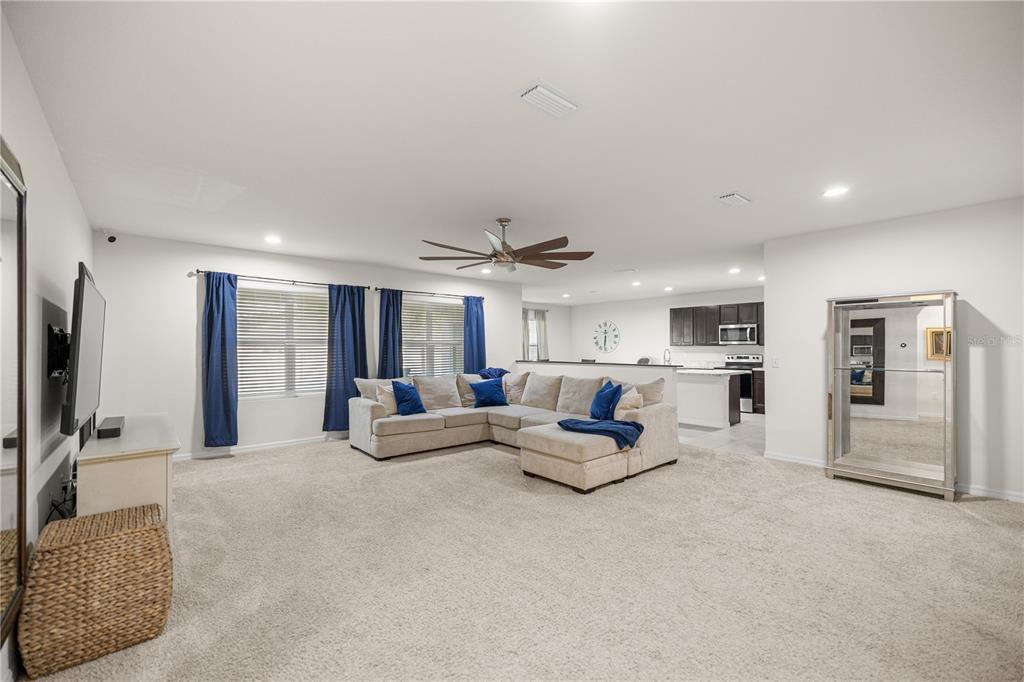 3833 Southeast 98th Place Belleview, FL 34420 - Photo 15 of 34 a living room with furniture and a flat screen tv