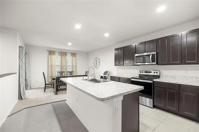 a kitchen with a sink stove and microwave