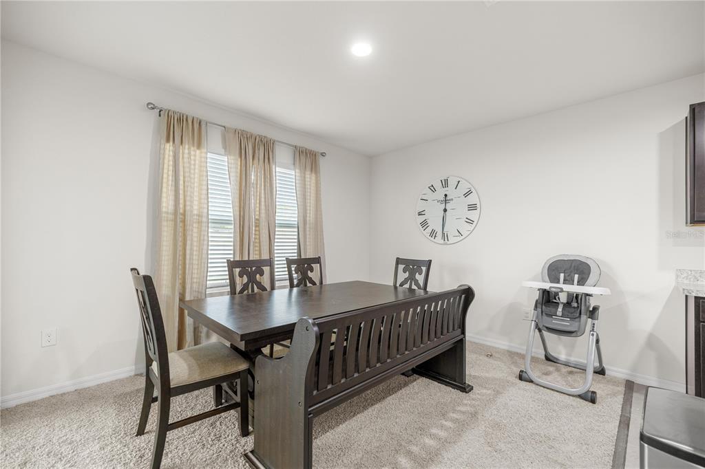3833 Southeast 98th Place Belleview, FL 34420 - Photo 17 of 34 a dining room with furniture and window