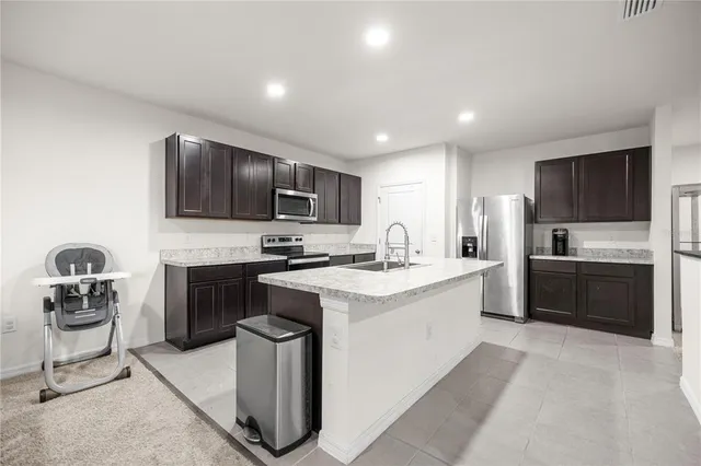 a kitchen with a sink cabinets and stainless steel appliances