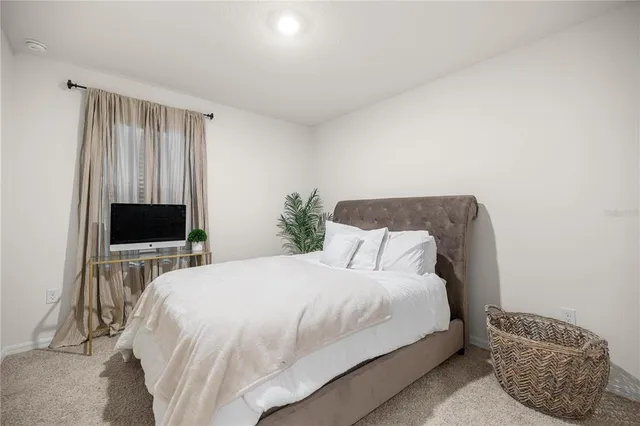 a bedroom with a bed and a television