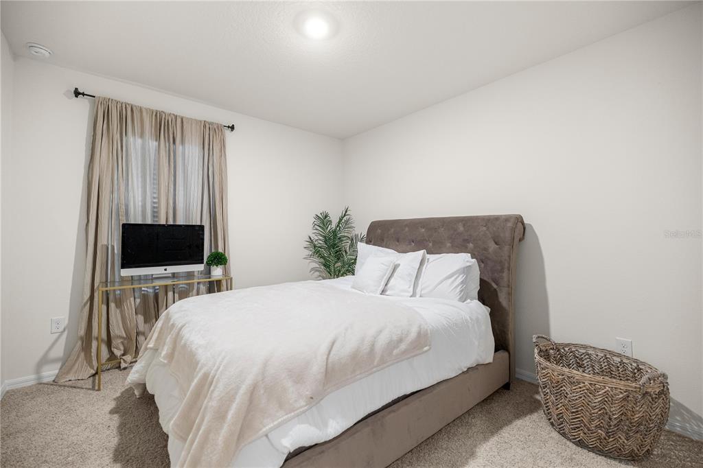 3833 Southeast 98th Place Belleview, FL 34420 - Photo 20 of 34 a bedroom with a bed and a television