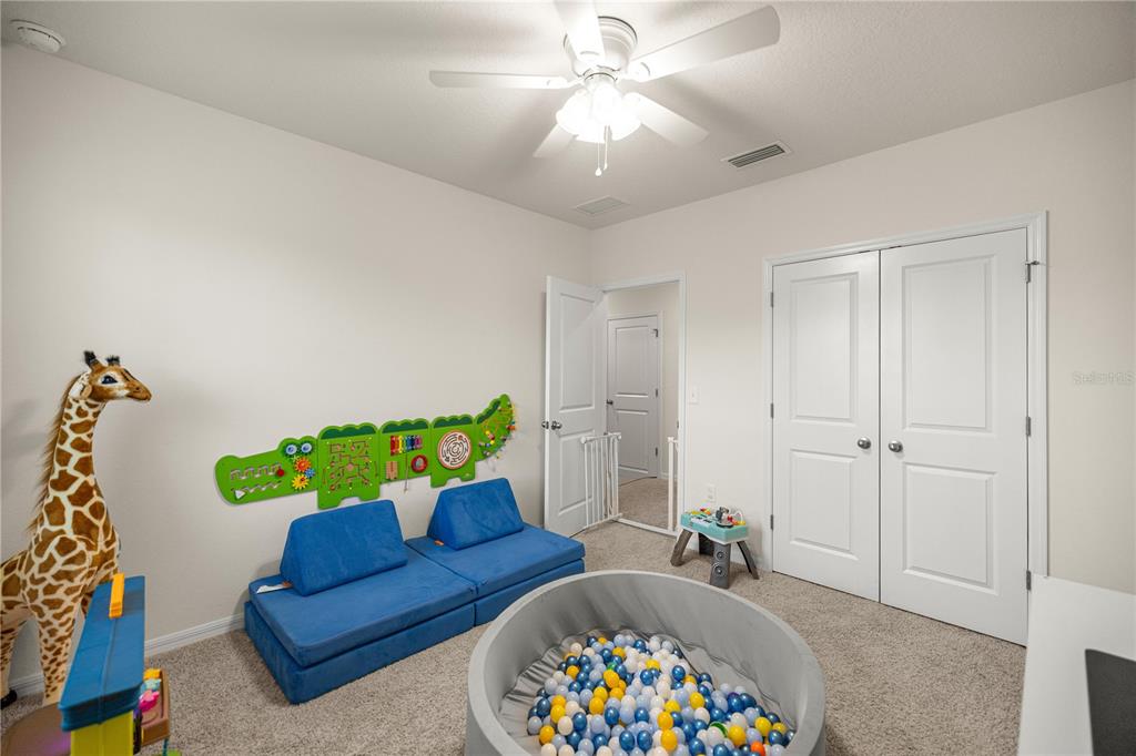 3833 Southeast 98th Place Belleview, FL 34420 - Photo 26 of 34 a living room with furniture and a rug