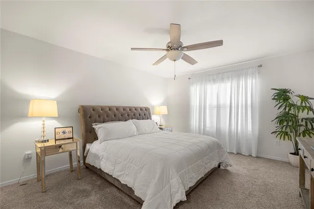 a bedroom with a bed and a potted plant