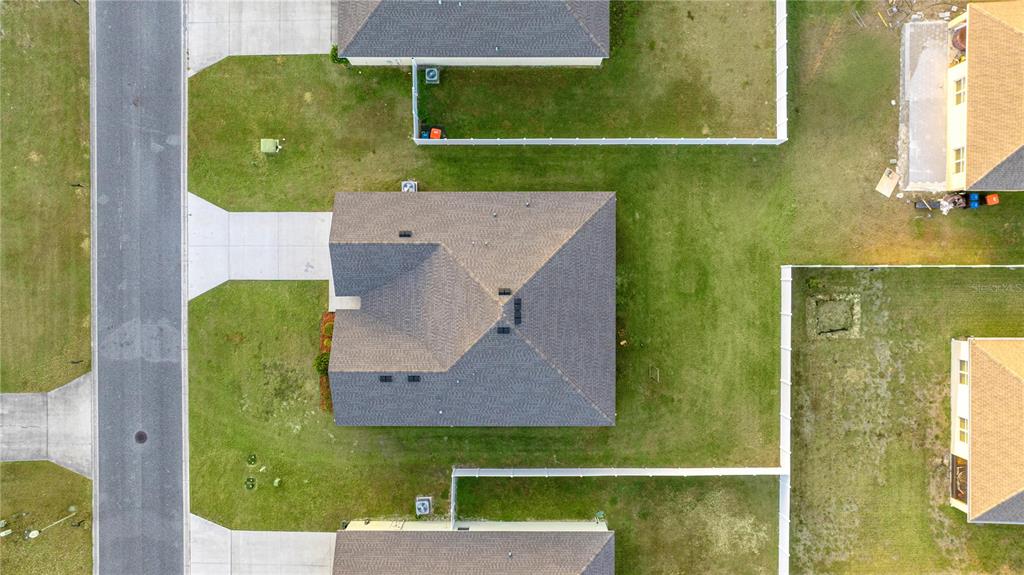 3833 Southeast 98th Place Belleview, FL 34420 - Photo 9 of 34 an aerial view of a house with a swimming pool